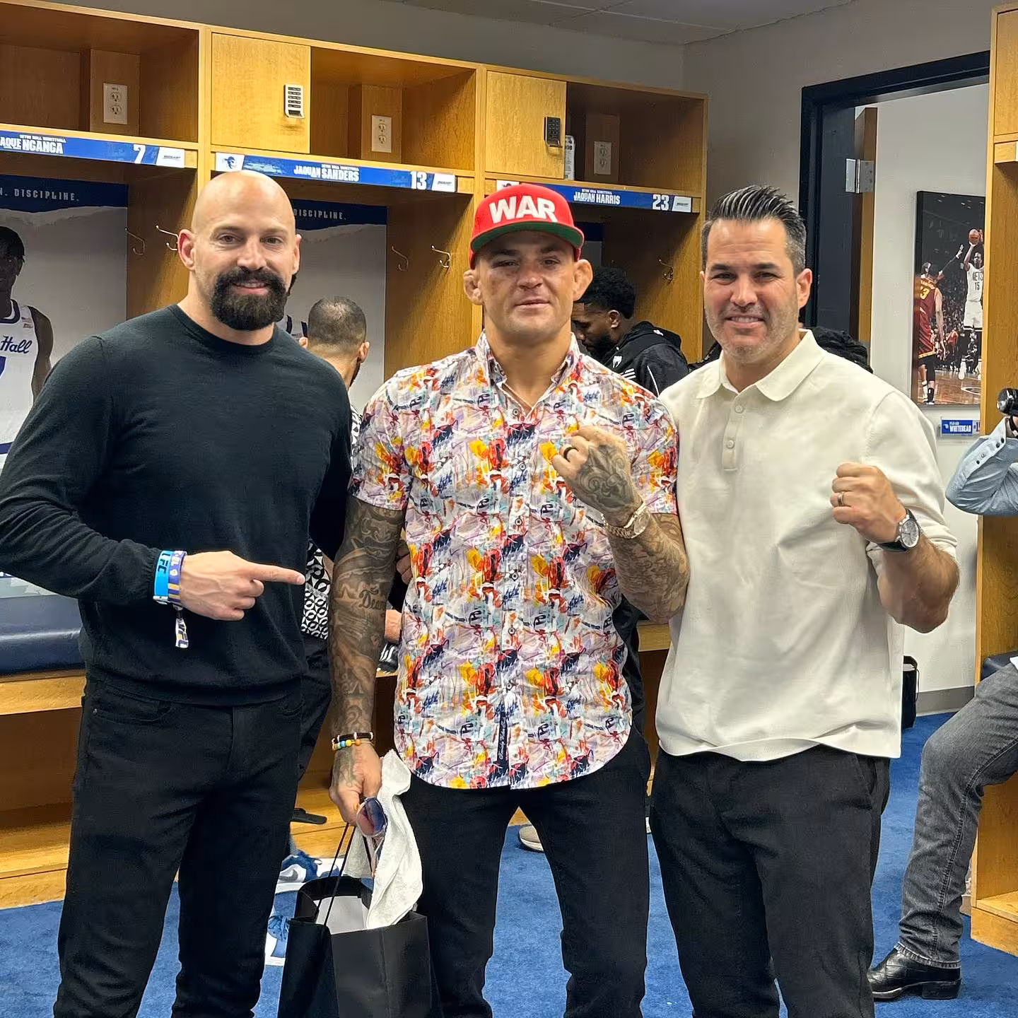 Tiki Ghoson Dana White and Hunter smoking cigars by a rooftop pool at night with luxury high rise buildings in the background during a UFC related event